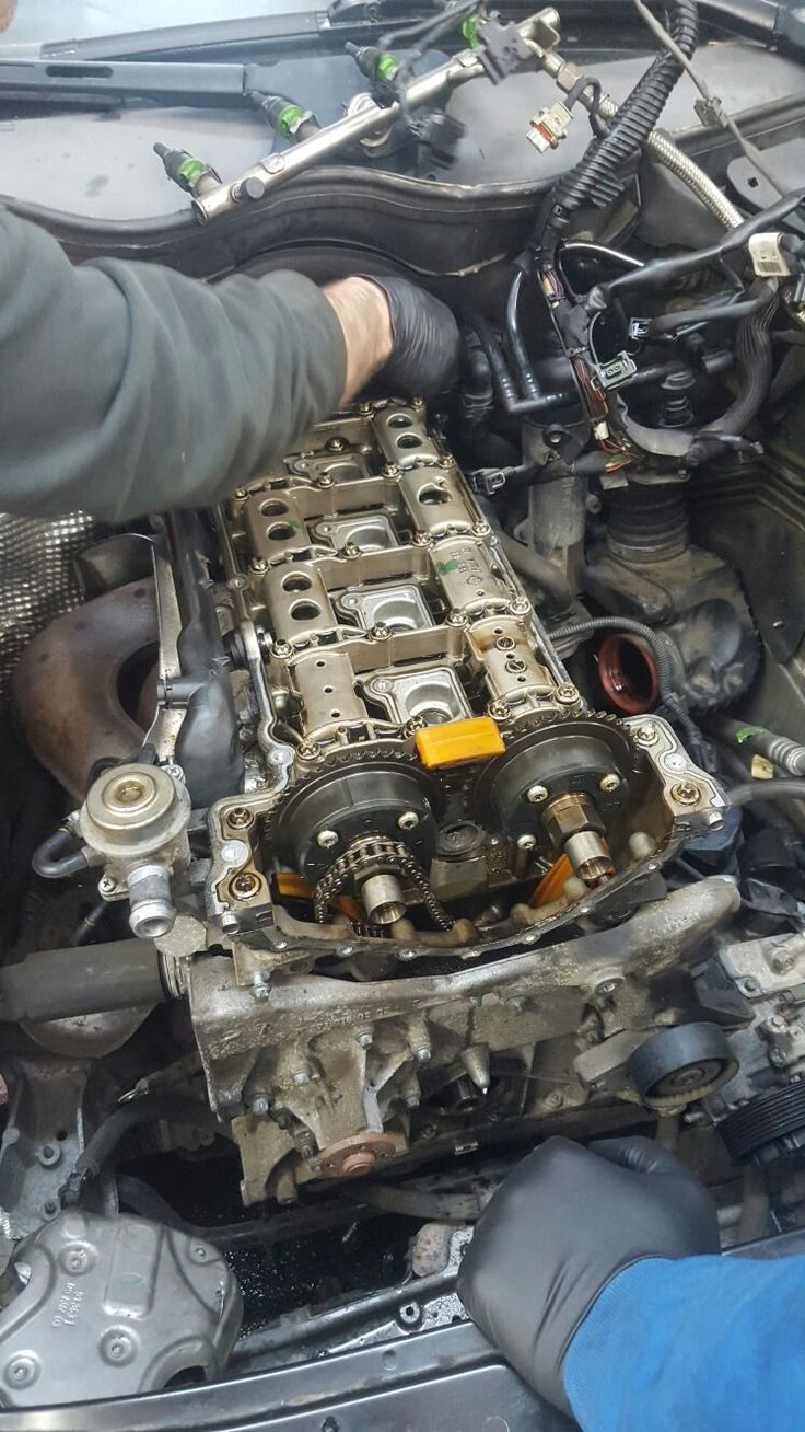 Hands working on an engine in the workshop