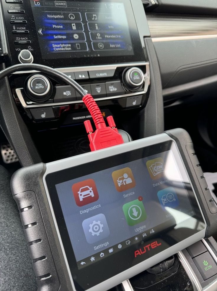 Diagnostic tool connected to a car dashboard